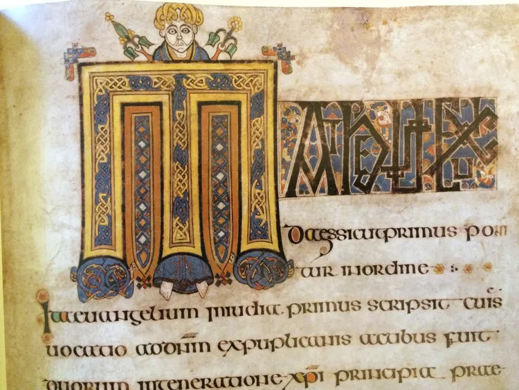 Book of Kells sample showing a decorated capital form and insular uncial forms
